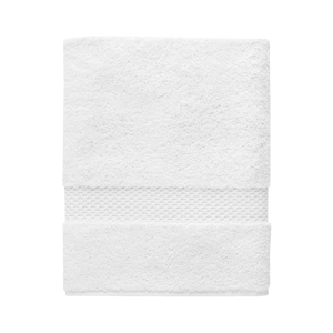 A neatly folded Yves Delorme Etoile Bath Towel in Blanc, made from organic cotton with a textured band design, is displayed against a plain background.