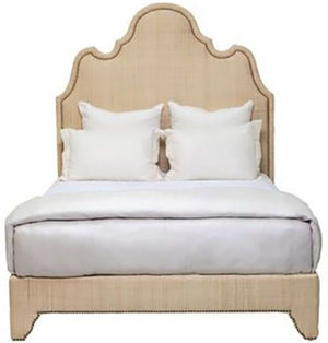 Ingrid Raffia Bed, King by Oly, with an ornate headboard featuring nailhead detail, dressed in white sheets and pillows.