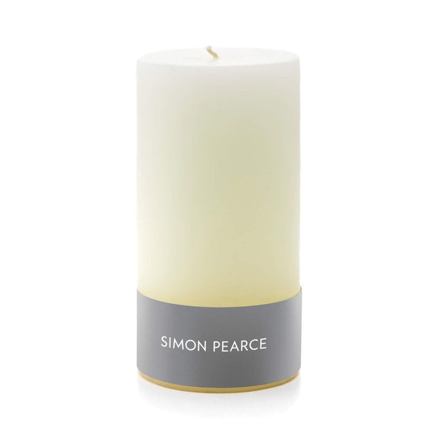 A white cylindrical Simon Pearce Ivory Pillar Candle, 3" x 6" with a gray band at the bottom on a white background. Handmade candles.