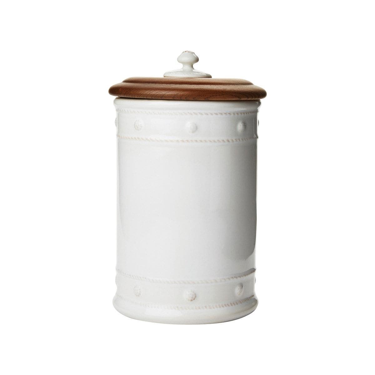 The Juliska Berry & Thread Whitewash 11.5" Canister features raised dot and basket weave details on white ceramic stoneware and a round wooden lid with a knob, displayed against a plain white background.