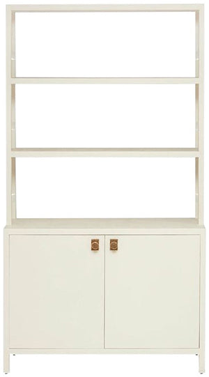 The Jake Bookcase by Made Goods is crafted from White Faux Belgian Linen, featuring three open shelving units and a two-door cabinet with gold handles for ample bottom storage.