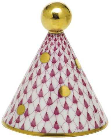 The Herend Party Hat is a cone-shaped porcelain decoration with hand-painted gold dots, a purple fishnet pattern on white, and a gold sphere accent on top.