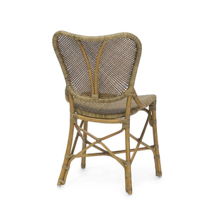 The Jordan Side Chair, by PALECEK, features a hand-woven rattan peel backrest and seat. Shown from the rear, it highlights its curved back and is supported by a sturdy pole rattan frame with crossed braces, all finished in a warm honey hue.