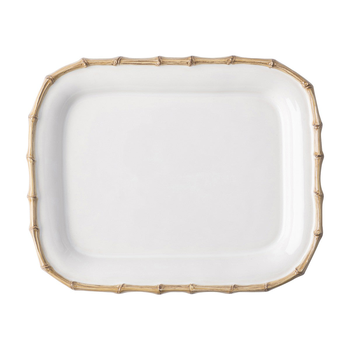 The Juliska Classic Bamboo Small Rectangular Platter is a white ceramic stoneware plate with a raised edge and gold bamboo-style border, adding an exotic touch to any setting. Photographed on a white background.