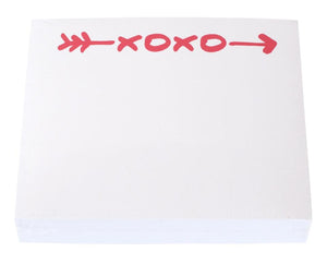 The XOXO Large Notepad by Black Ink features white pages with a red arrow and "XOXO" repeated at the top, set in a sleek Lucite Notepad Holder—perfect for everyday notes on quality paper.