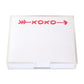 The XOXO Large Notepad by Black Ink features a clear Lucite holder and quality paper. The top sheet displays a bold red "XOXO" and a red arrow across the top.