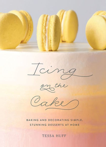 Yellow macarons on top of a pastel-colored "Icing on the Cake" cookbook, illustrating pastry technique by Abrams.