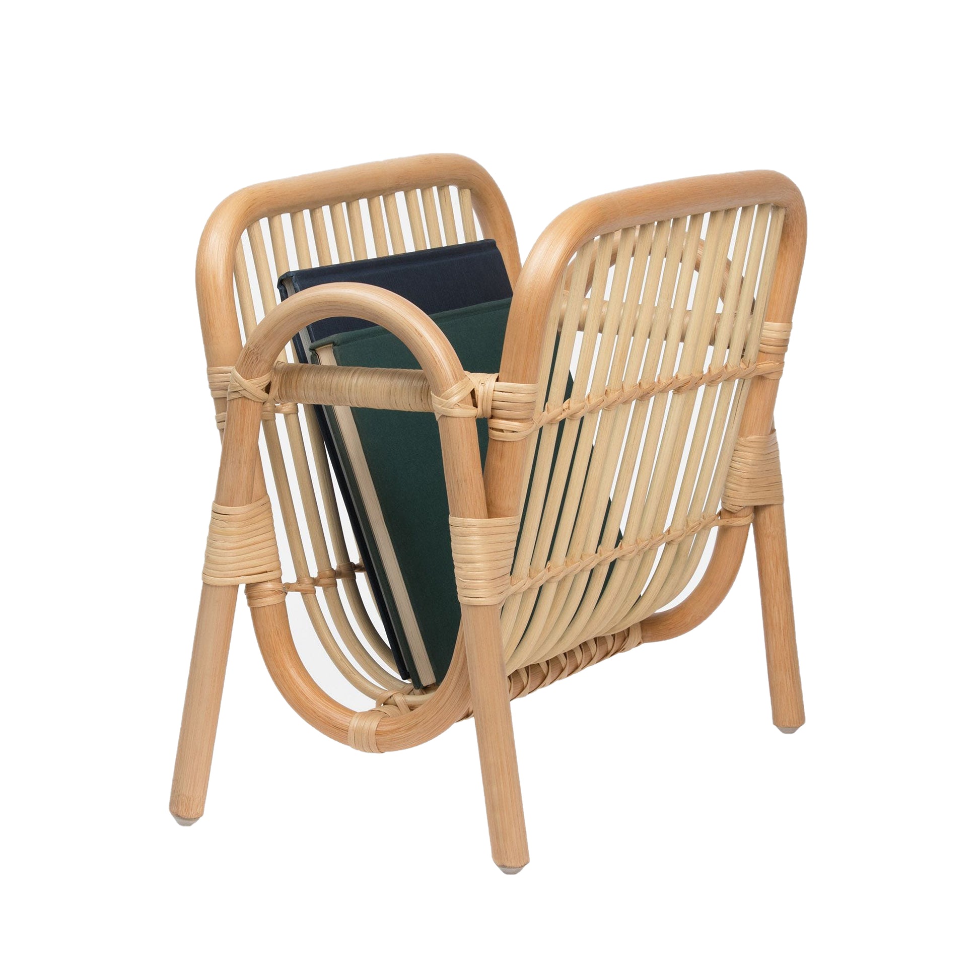 The Makassar Magazine Holder by Pigeon & Poodle features a gently curved rattan design, showcased holding several books against a white background.