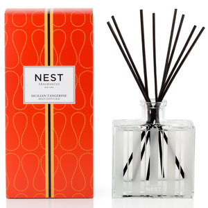 A Nest Sicilian Tangerine Diffuser box sits beside a clear bottle with black reeds, ready to fill your space with bright scents of Sicilian tangerine and bergamot.