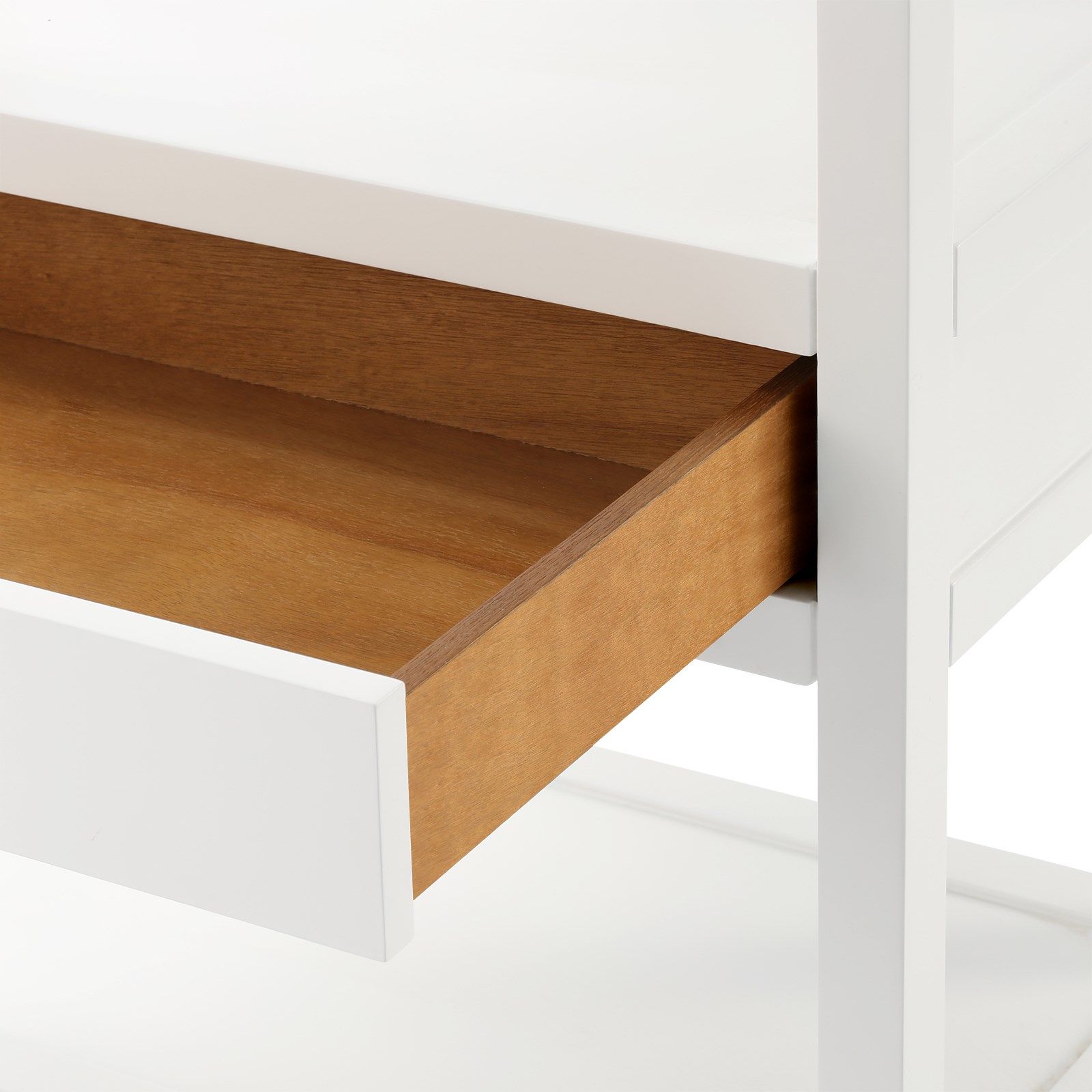 Close-up of a partially open wooden drawer in a white desk reveals the modern campaign style of Bungalow5's Newport Etagere, White Lacquer. This piece features sleek lines and elegant design, crafted from lacquered wood to add sophistication and timeless charm to any space.