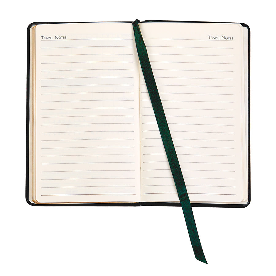 The "On the Green Score Book" by Graphic Image is an open notebook with lined pages labeled "Travel Notes," featuring a green ribbon bookmark—ideal for creating a personal leather score book to capture memorable moments on and off the golfer's course.