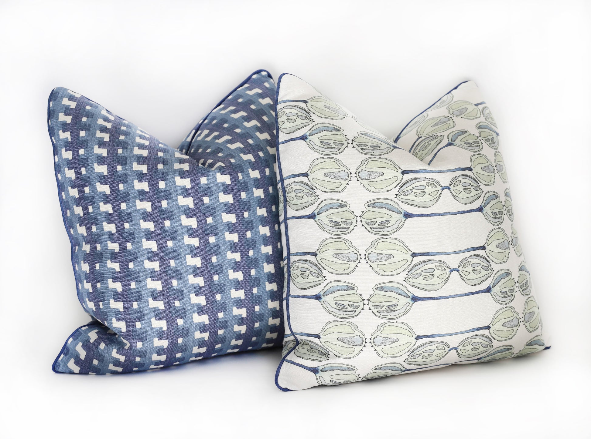 Two Cremaillere Indigo Pillows with blue and white designs, crafted from 100% linen and custom-made in the USA by Edgar Custom Drapery.
