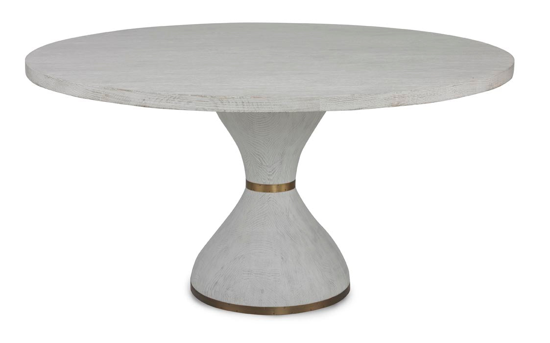 The Parrot Dining Table by Mr Brown is a round wooden dining table with a solid oak, hourglass-shaped pedestal base, enhanced with metal accents for a modern look.
