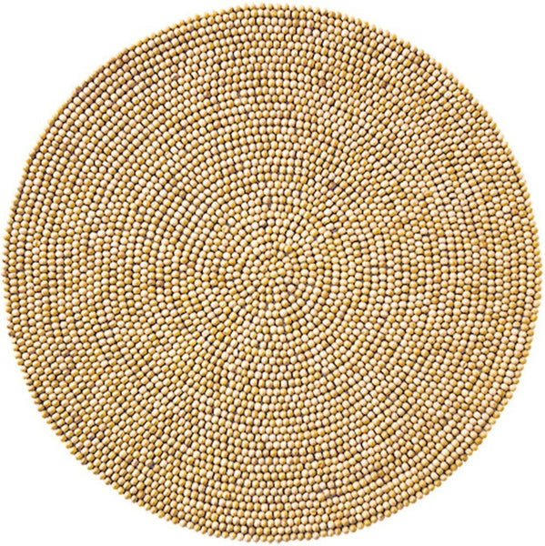 A circular, hand-beaded placemat, the Kim Seybert Natural Wood Bead Placemat, made of tightly coiled beige beads with a 15" diameter and 100% cotton backing by Kim Seybert.