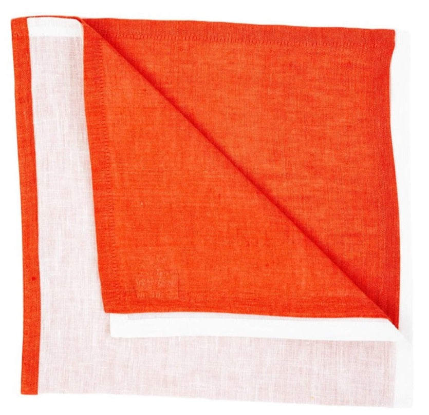 The Deborah Rhodes Resort Two-Tone Napkin Set features square linen napkins with orange on one side and white on the other, folded to show both hues—ideal for brightening up your summer table.