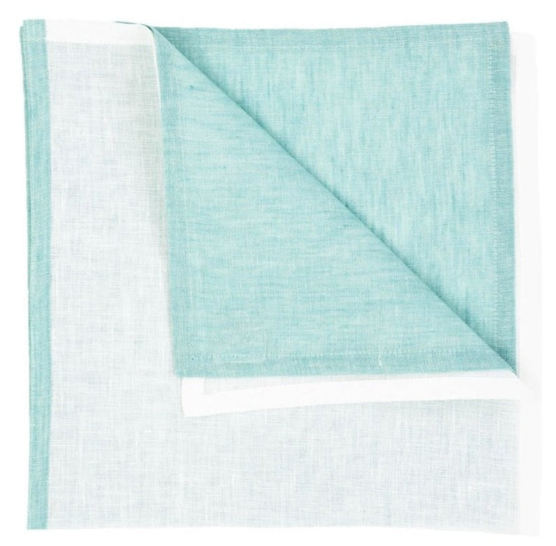 The Deborah Rhodes Resort Two-Tone Napkin Set features a light blue linen napkin, neatly folded to display both front and back sides against a white background—ideal for elevating your summer table.