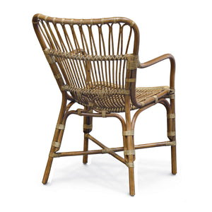 A PALECEK Retro Rattan Dining Arm Chair with a rounded backrest and armrests, featuring a woven pattern and brown wooden rattan frame.