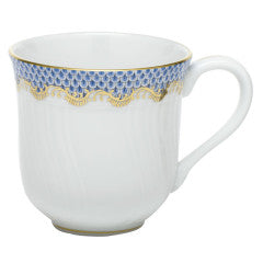 A porcelain mug with a handle, featuring a light blue and gold fish scale patterned rim, reminiscent of Herend's Fish Scale Serving Pieces.