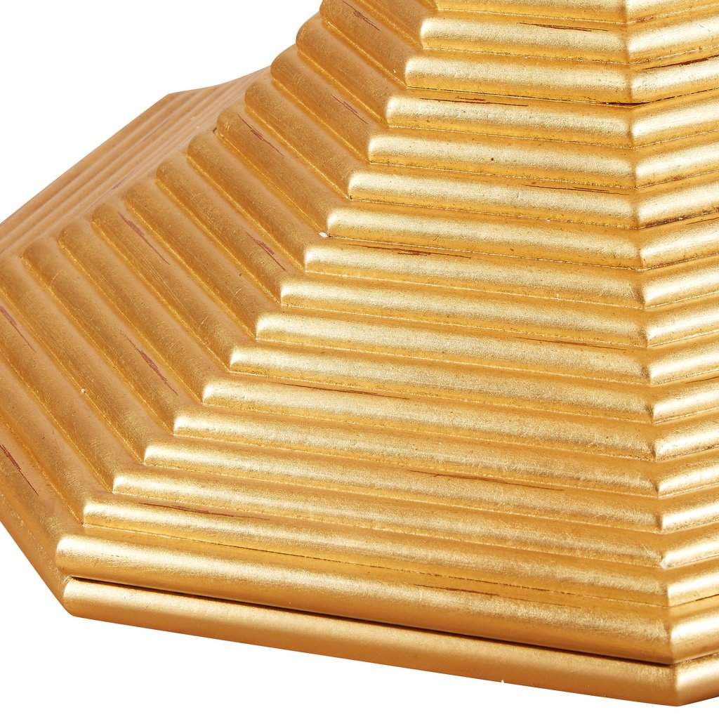 The Hourglass Table in Gold Patina by Bunny Williams features a golden, tiered, hexagonal pyramid design with ridged steps and a reflective finish, elegantly resting on an antique gold pedestal base.