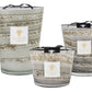 Three Baobab Collection Sand Atacama candles in varying sizes, featuring striped designs in neutral tones with black lids.