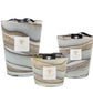 Three Baobab Sand Sonora Candles with swirled gray and tan designs, each infused with the scent of myrrh, displayed side by side, each with a branding tag.