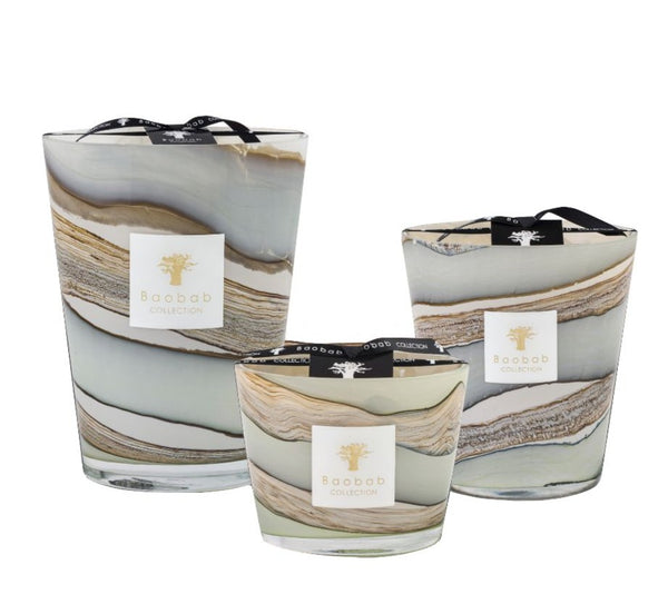 Three Baobab Sand Sonora Candles with swirled gray and tan designs, each infused with the scent of myrrh, displayed side by side, each with a branding tag.