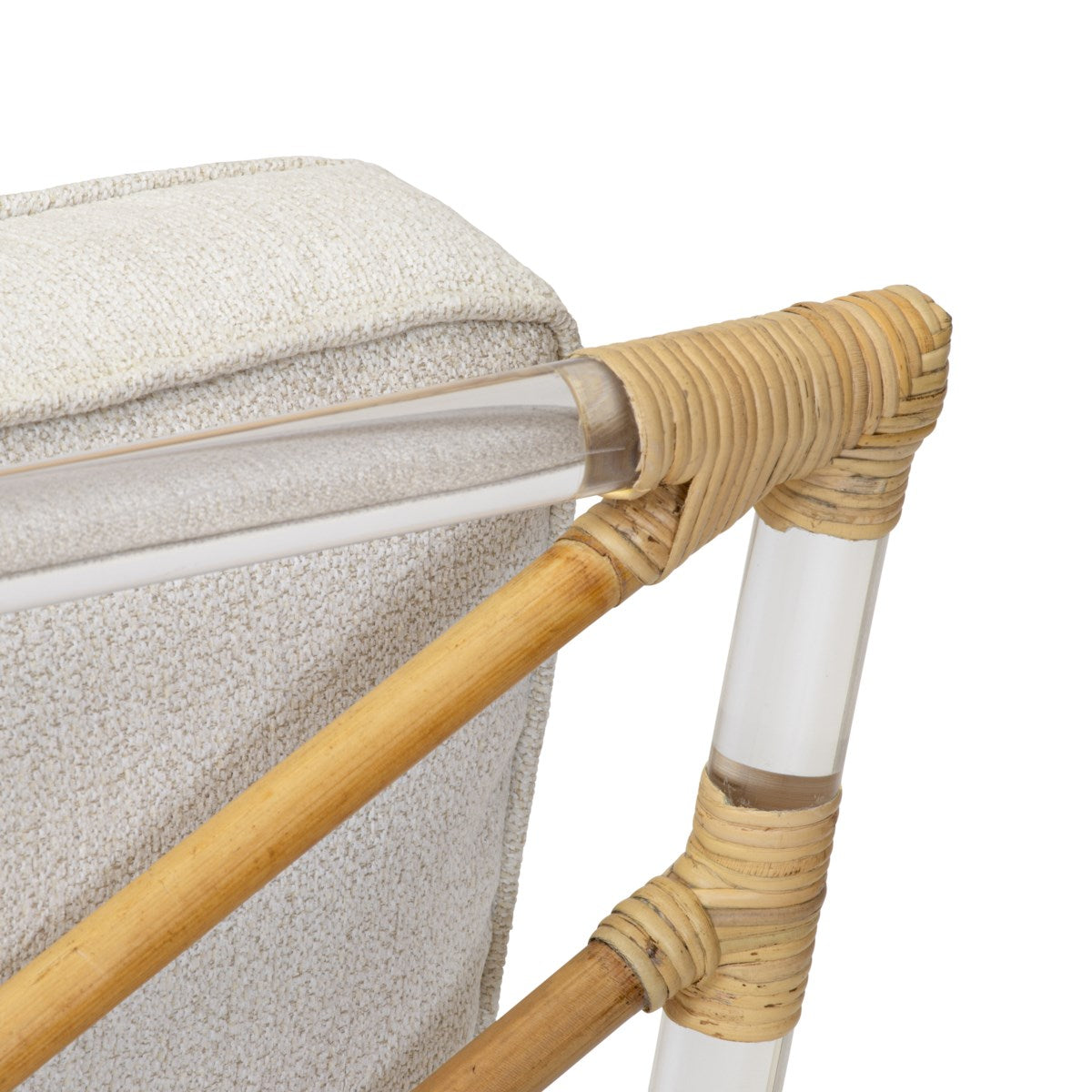 Close-up of the Selamat Sea Cliff Slipper Chair with hand-bent rattan details and clear acrylic supports. The upholstery features a light beige, textured Kravet Crypton Boucle fabric inspired by Sea Cliff.