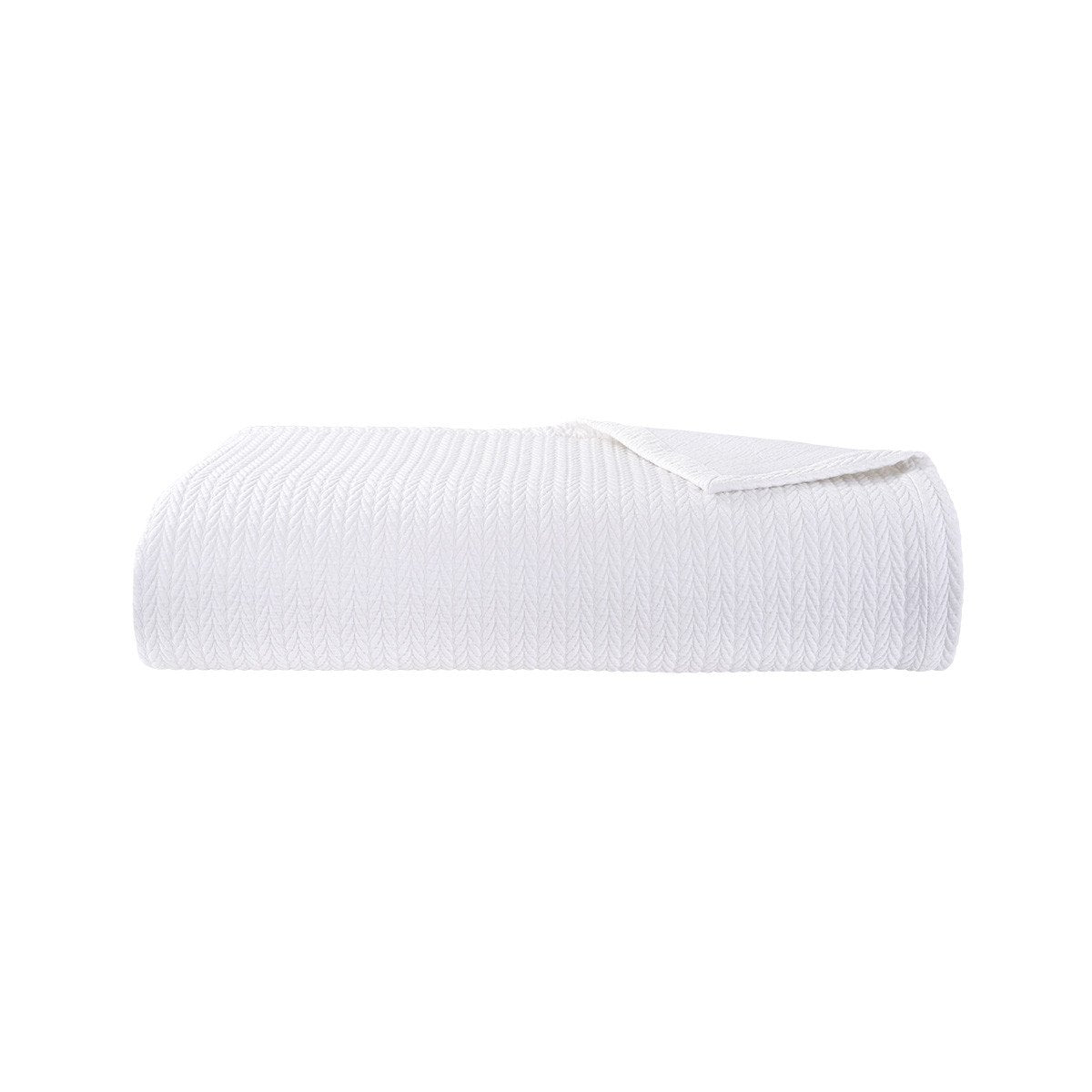 The Songe Blanc Quilted Coverlet by Yves Delorme is a white textured cotton blanket with a subtle chevron pattern, shown folded against a plain white background.