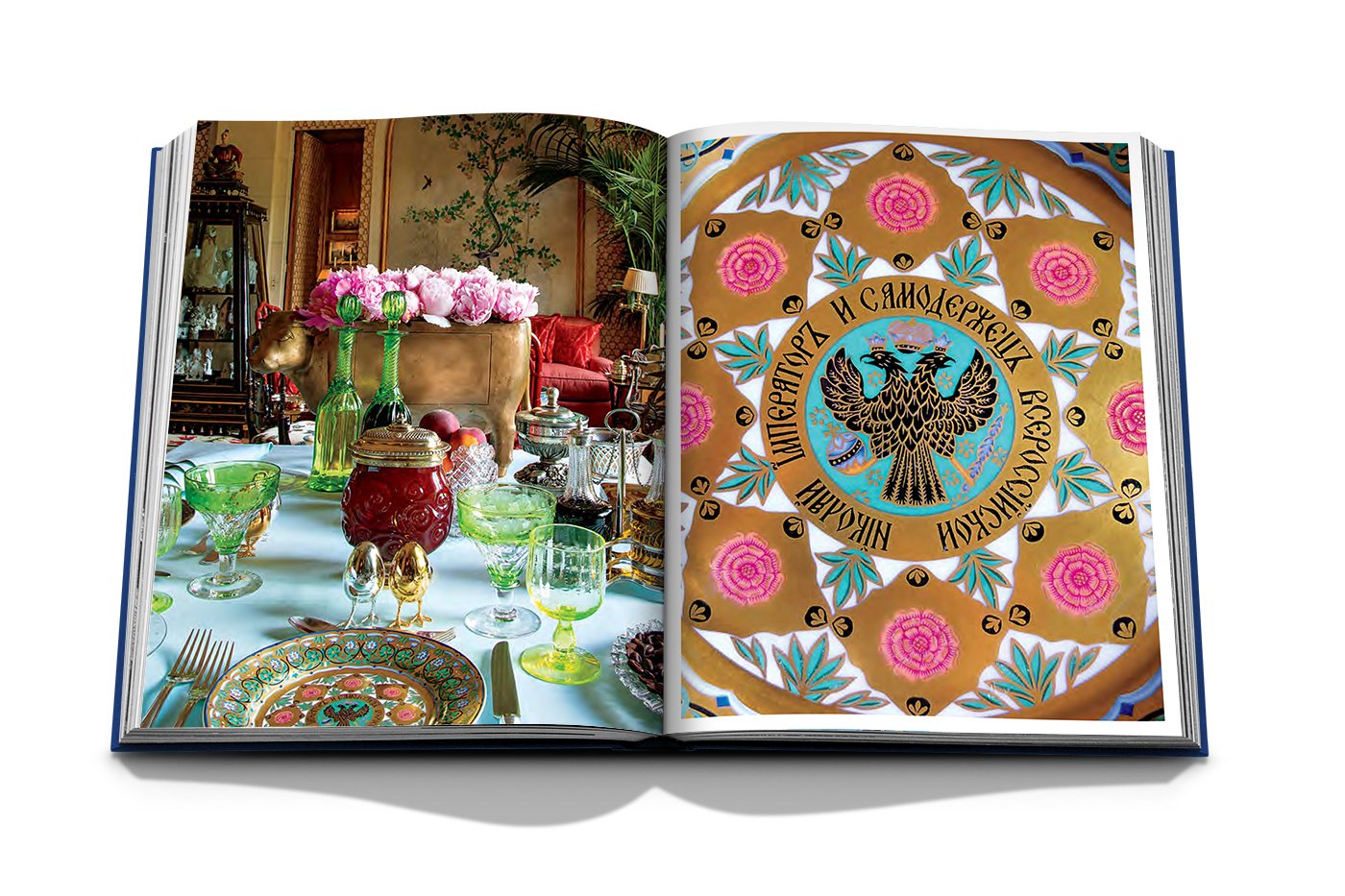 An open book, "Valentino: At the Emperor's Table" by Assouline, reveals ornate dinnerware with a Russian eagle. The left page features a haute couture table setting with exquisite glassware and flowers, embodying Valentino Garavani's refined elegance.