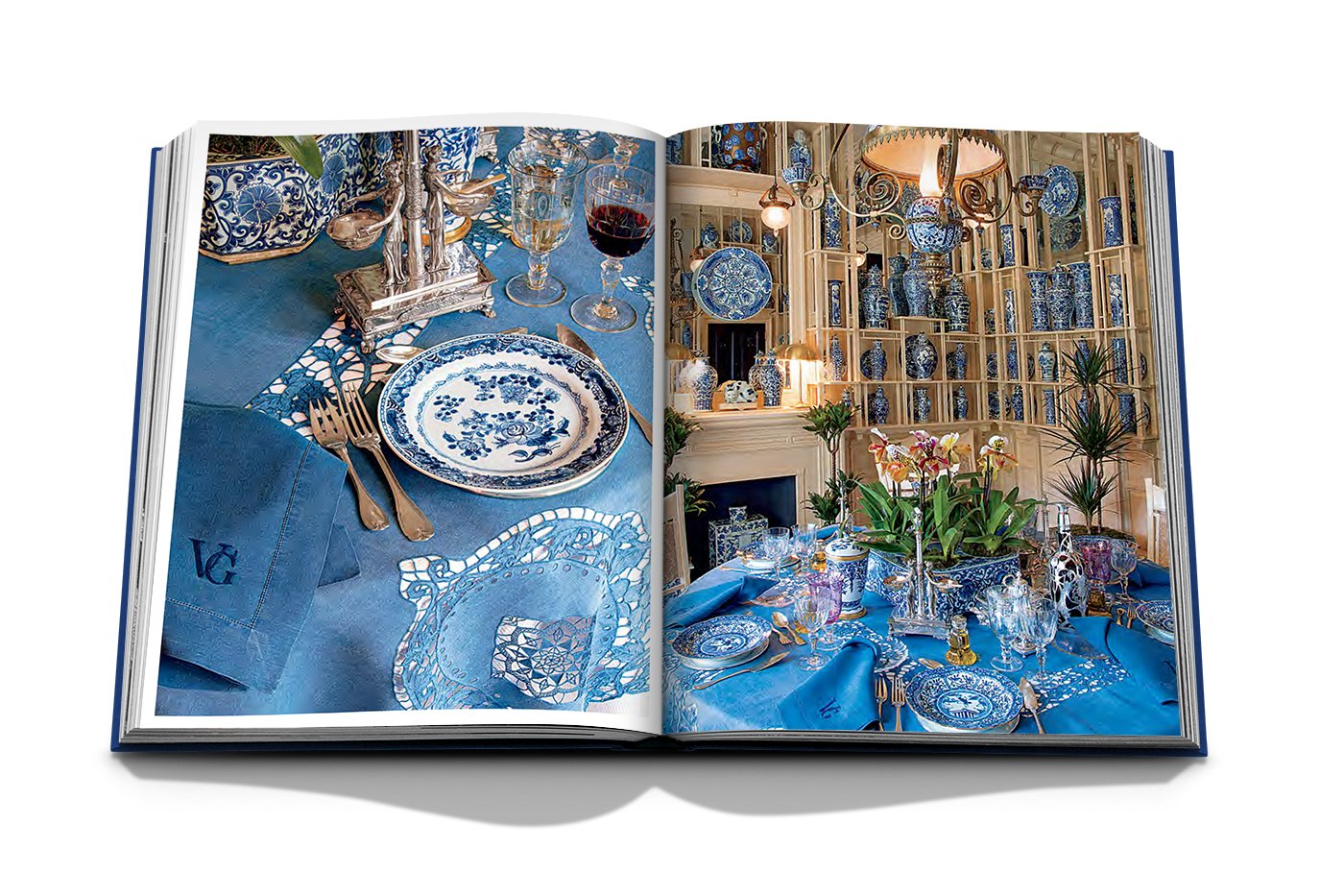 The book "Valentino: At the Emperor's Table" by Assouline showcases an elegant dining setup with blue and white patterned china, glassware, cutlery, and a floral centerpiece, matching porcelain that complements the exquisite table settings reminiscent of haute couture.