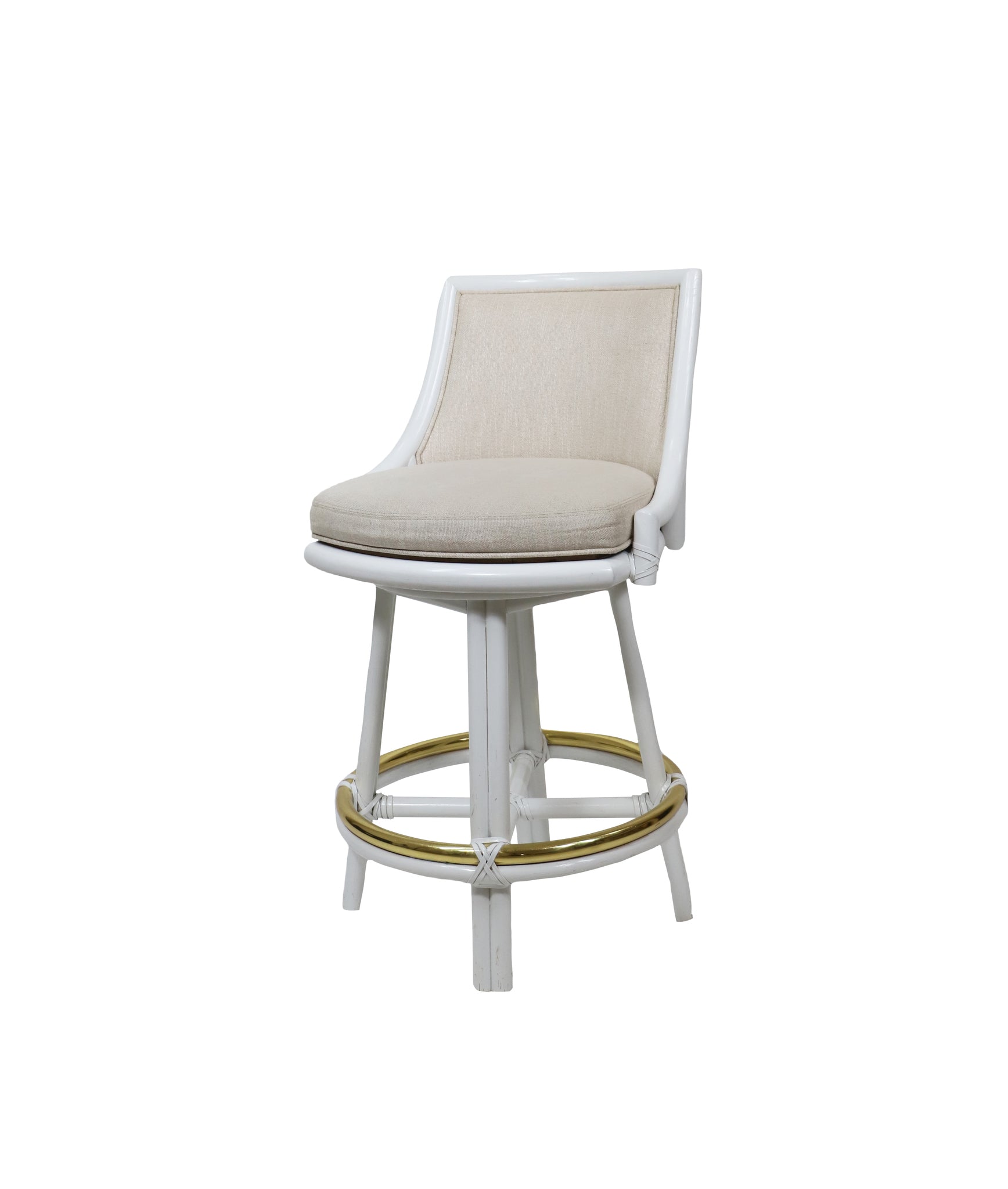The McGuire Furniture White Rattan Swivel Bar Stool with Natural Linen combines a cushioned seat, curved backrest, and gold circular footrest for a stylish touch to any home or brand.