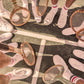 A tennis team in white shorts and shoes stands in a circle on the court, holding wooden rackets—evoking Gray Malin's "The Tennis Team Coral Beach Club" (White Frame, 29.5" x 41.5") from Gray Malin.