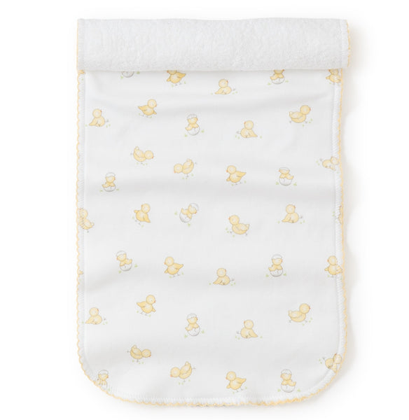 A white Pima cotton towel with Kissy Kissy Hatchlings Print burp cloth on it.