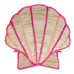 The Shell Flower Vase by Mercedes Salazar is crafted by skilled artisans in Bogotá, featuring a seashell design with pink and orange natural raffia trim.