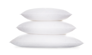 Three Matouk Valletto Goose Down Pillows in Queen size are stacked atop each other against a plain backdrop.
