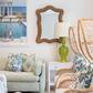 A living room with wicker chairs and a large mirror, featuring a Marjorie Lamp by Christopher Spitzmiller.