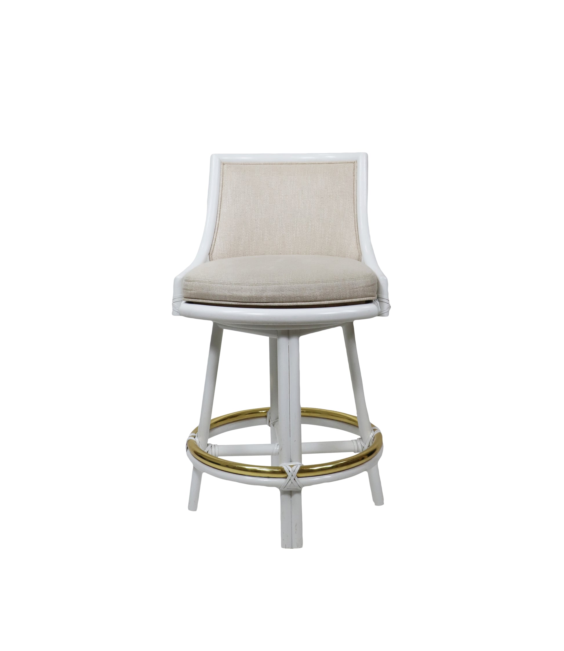 The White Rattan Swivel Bar Stool with Natural Linen by McGuire Furniture features a cushioned seat and backrest, four legs, and a circular gold footrest, making it an ideal choice for any modern kitchen or bar area.